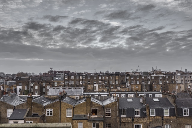 Classic rooftops in London with grey sky and clouds