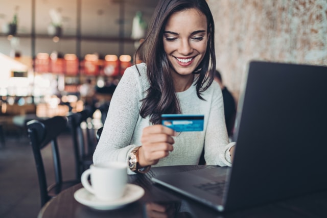 Smiling woman making a credit card purchase-774