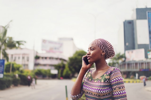 photo of a woman outside talking on her mobile phone
