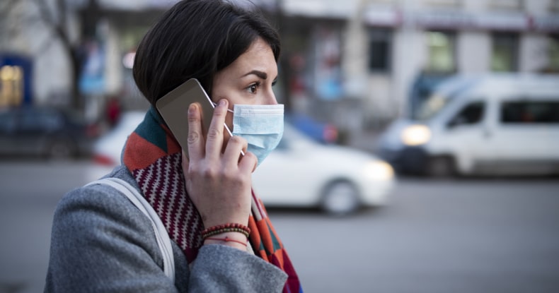 photo of a Young Woman With Face Mask Talking On The Phone.