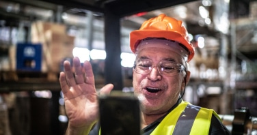 employee doing a video call on mobile phone at warehouse industry