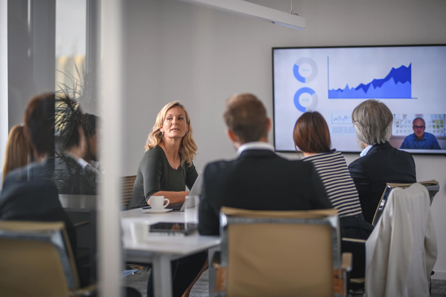 Businesswoman Listening to Associate During Video Conference-891