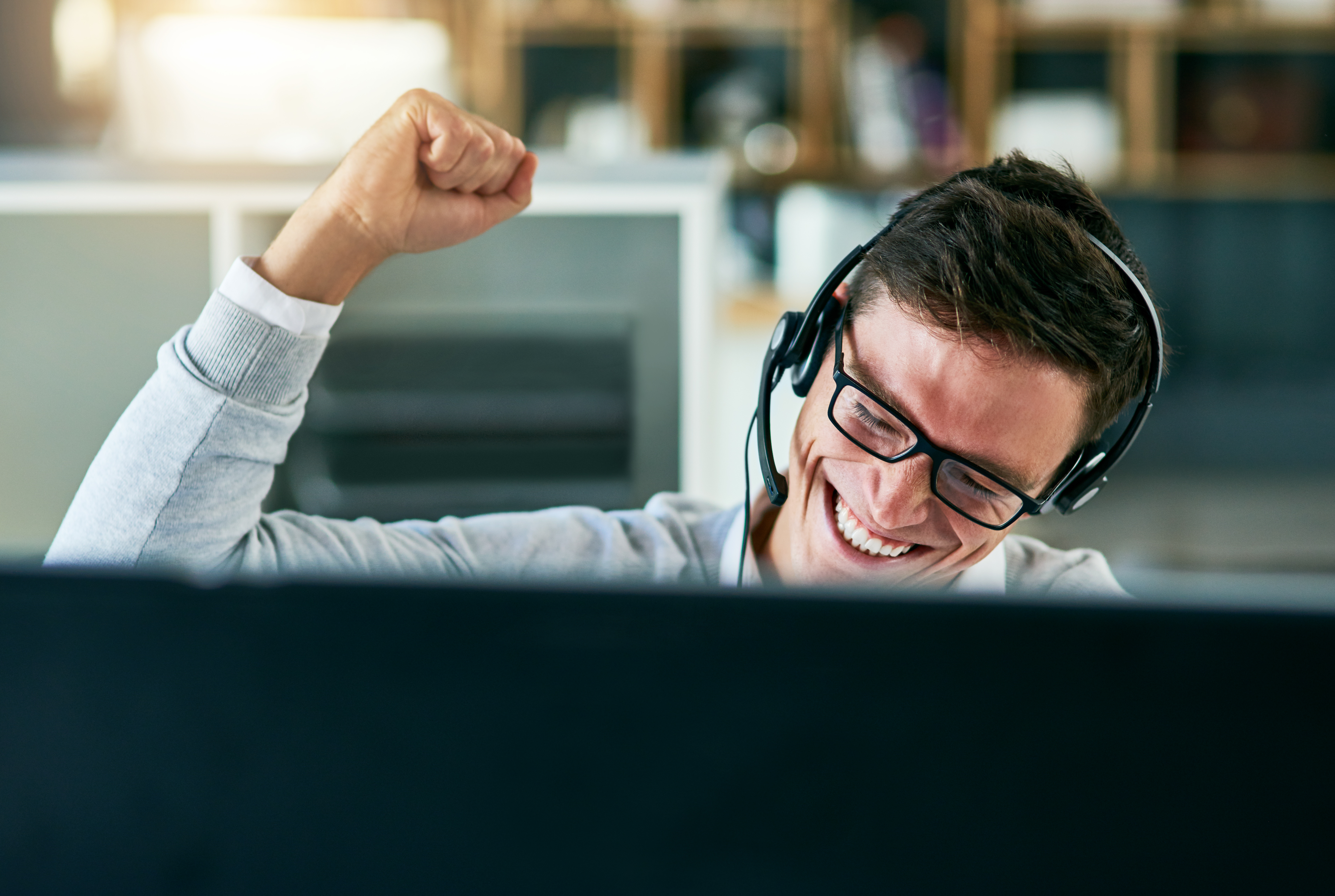 call centre agent cheering while working in an office